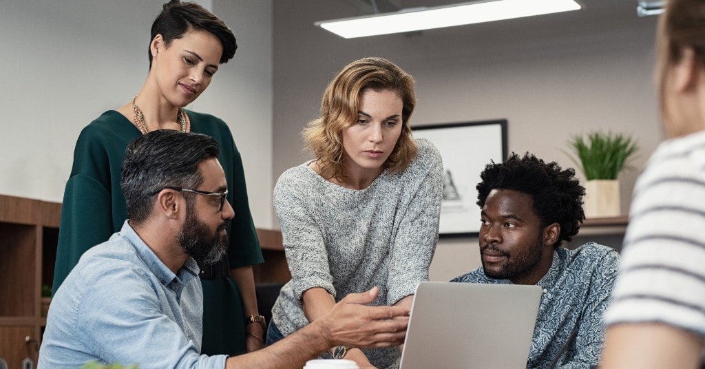 Fulfizo team collaborating around a laptop